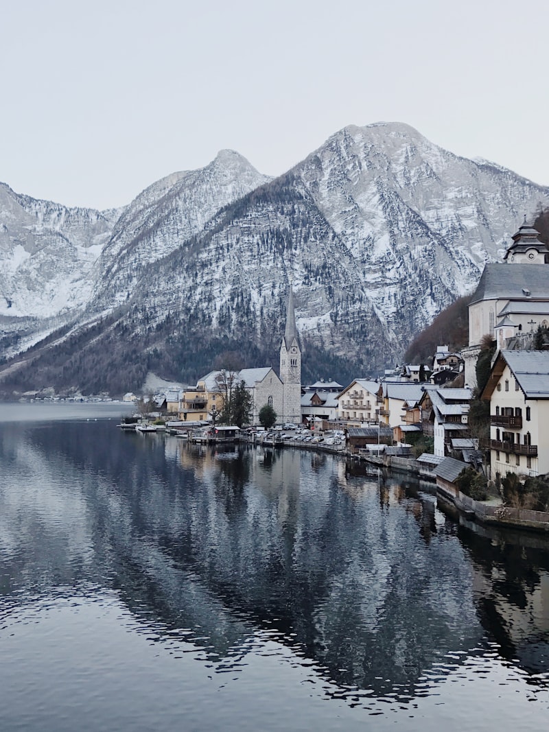 Scenic lakeside village with mountains representing Medicine Park's distinctive outdoor lifestyle appeal