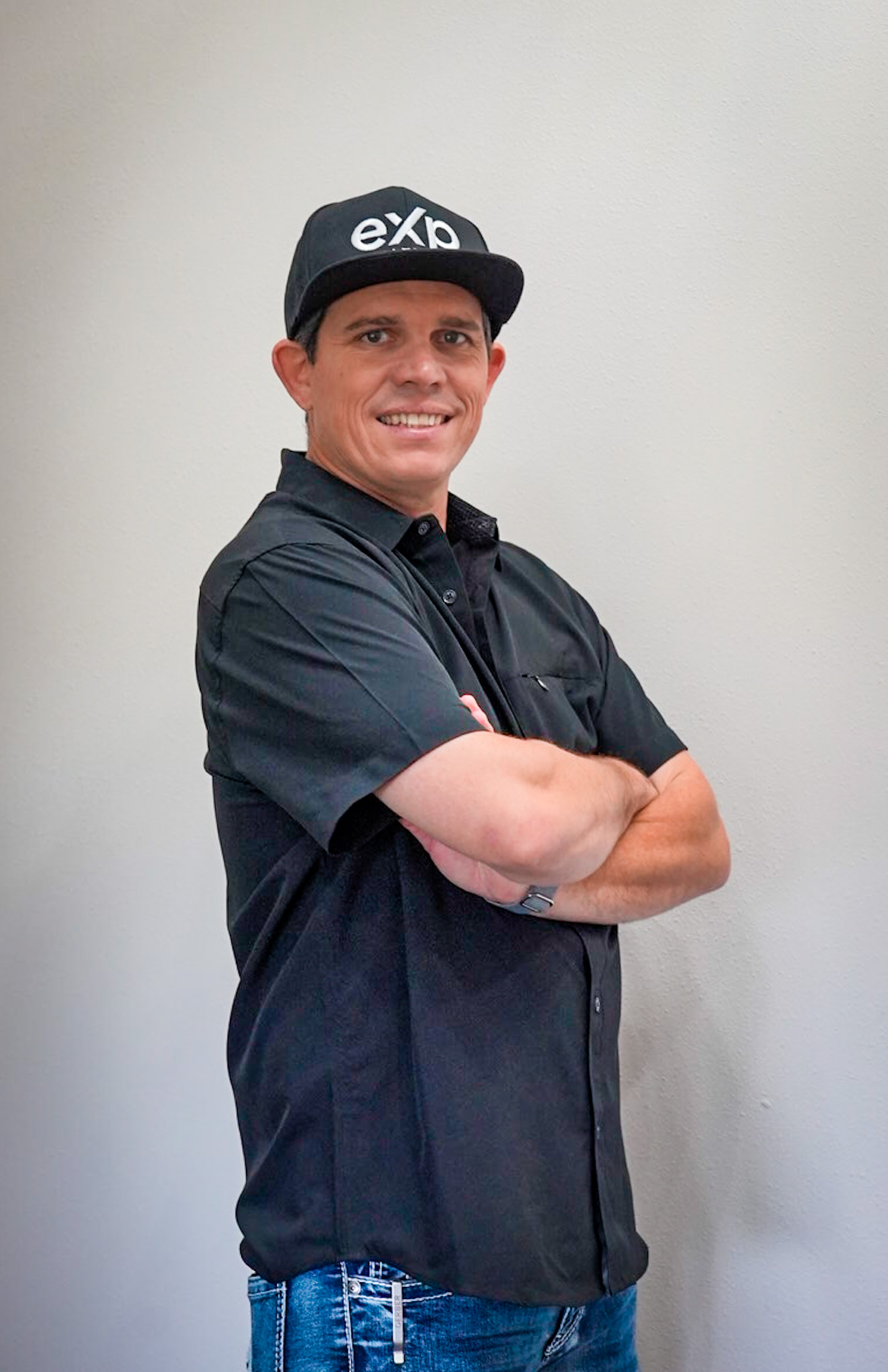 Travis Wright seated in a professional portrait with a direct expression
